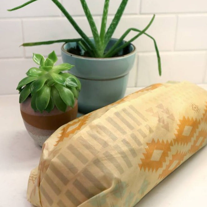 Bread covered with extra large beeswax bread and greens wrap on counter